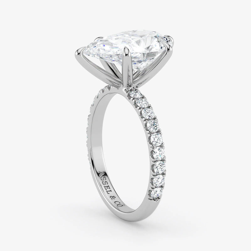 Diamond ring with a white gold band on a light gray background