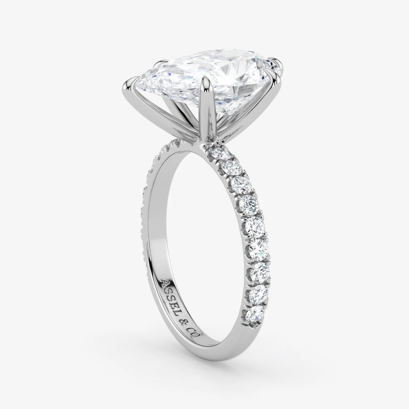 Diamond ring with a white gold band on a light gray background