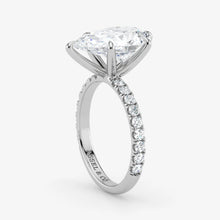 Diamond ring with a white gold band on a light gray background