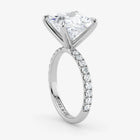 Diamond ring with a triangular stone and smaller diamonds on a white background