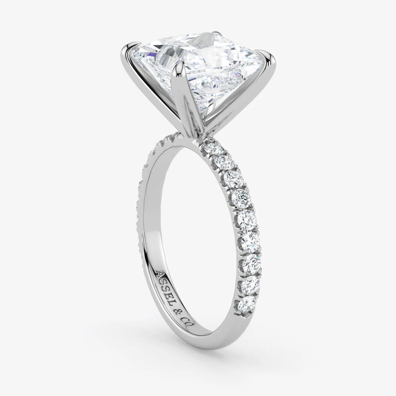 Diamond ring with a triangular stone and smaller diamonds on a white background