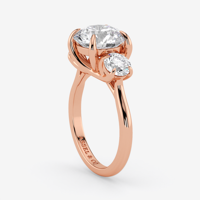 Rose gold ring with two clear gemstones on a white background