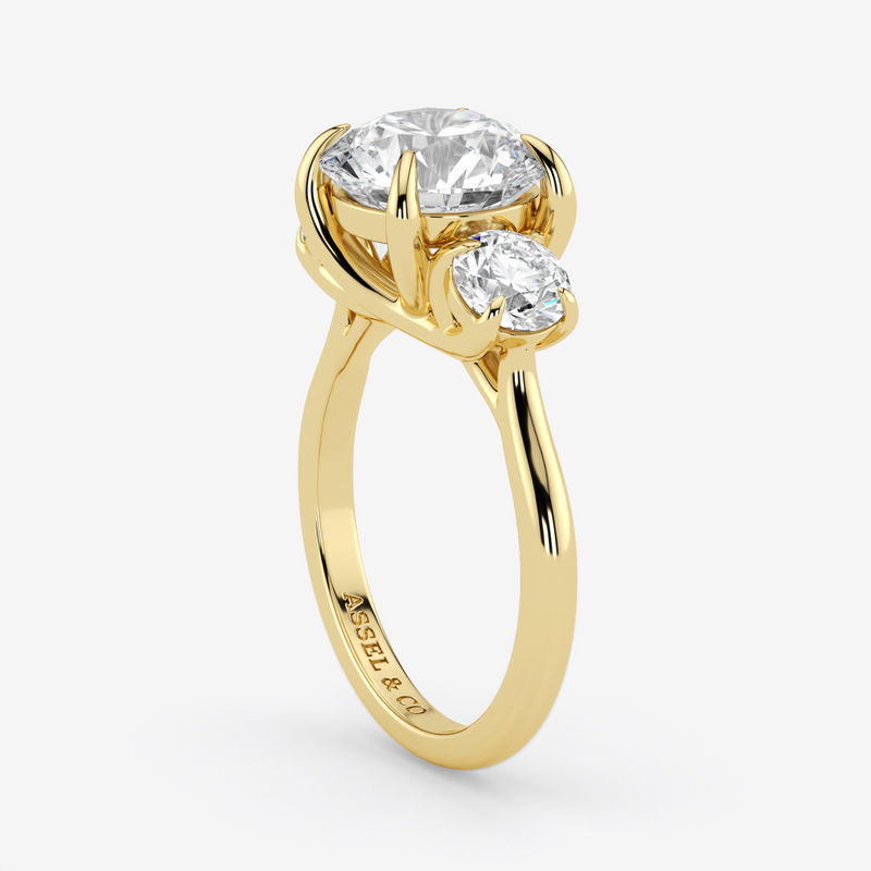 Gold ring with two diamonds on a white background