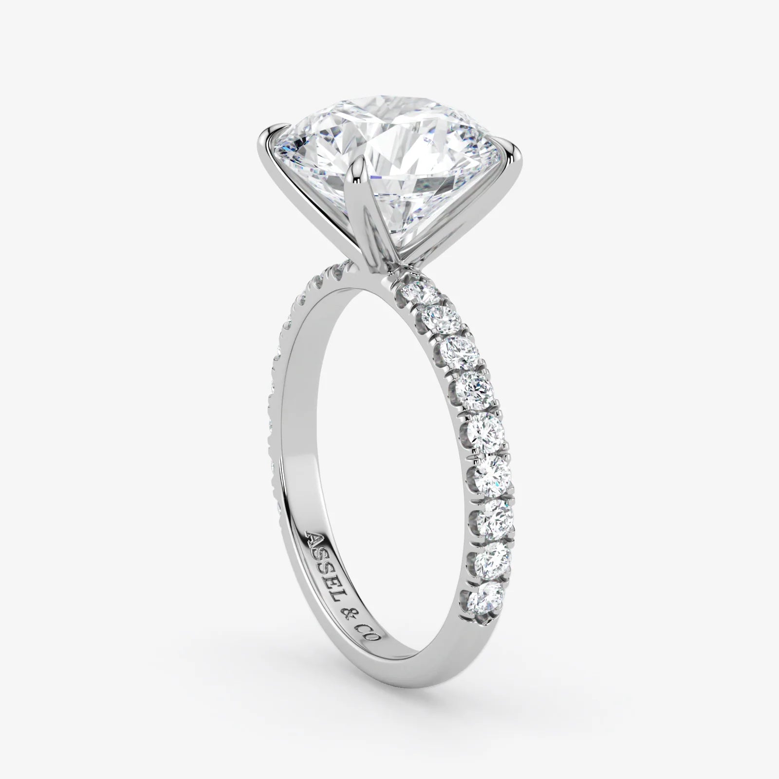 Diamond ring with a prominent central gemstone and smaller stones on the band against a white background.