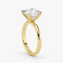 Close-up view of cushion cut lab-grown diamond in polished 18K yellow gold