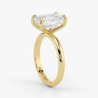 Close-up view of emerald cut lab-grown diamond set in polished 18K yellow gold