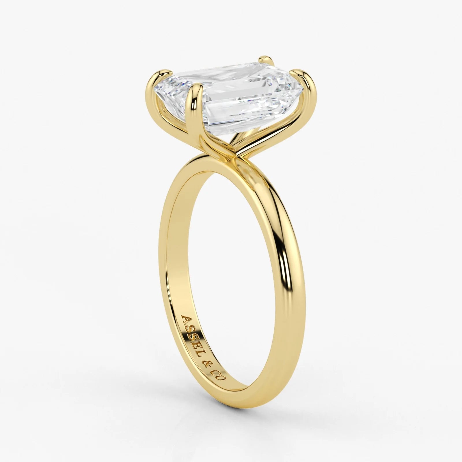 Close-up view of emerald cut lab-grown diamond set in polished 18K yellow gold