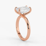 Side profile of emerald cut lab-grown diamond ring with hidden halo in rose gold setting