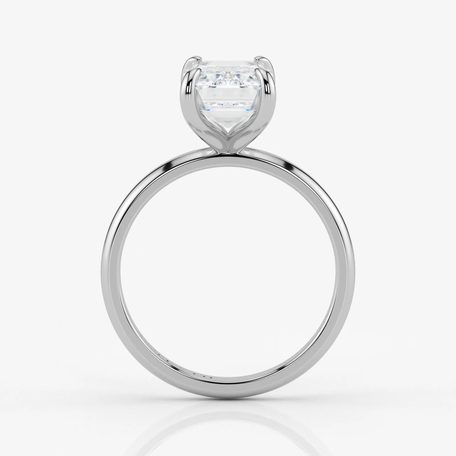Side profile of emerald cut lab-grown diamond ring in sleek 18K white gold